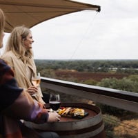 Two friends enjoying a wine and produce platter at Banrock Station overlooking the Riverland